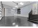 Large garage with sealed flooring, overhead lights, stairs and access to the main house at 304 Acadia Ln, Celebration, FL 34747