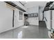 Garage with finished walls, sealed floor, stairs to the home and overhead lighting at 304 Acadia Ln, Celebration, FL 34747