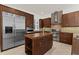 Gourmet kitchen featuring stainless steel appliances, a center island and wooden cabinetry at 304 Acadia Ln, Celebration, FL 34747