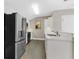 Well-lit kitchen features stainless steel appliances and stylish tiled flooring at 304 Acadia Ln, Celebration, FL 34747