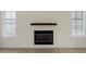 Bright living room with fireplace and plantation shutters on the windows at 304 Acadia Ln, Celebration, FL 34747