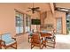 Outdoor kitchen with stainless steel grill, a ceiling fan, a TV and ample seating for dining and entertaining at 304 Acadia Ln, Celebration, FL 34747