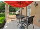 Outdoor patio with a table, chairs, and an umbrella, perfect for enjoying the beautiful view and breeze at 304 Acadia Ln, Celebration, FL 34747