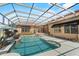 Beautiful screened-in pool and spa with tile surround, lush landscaping, and ample patio space for outdoor living at 304 Acadia Ln, Celebration, FL 34747