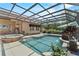 Inviting pool and spa with screened enclosure and manicured landscaping for outdoor enjoyment at 304 Acadia Ln, Celebration, FL 34747