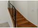 Wooden staircase with black iron railing, providing a modern and stylish look at 304 Acadia Ln, Celebration, FL 34747