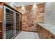 Custom wine cellar with wine refrigerators, counter, and wood walls at 304 Acadia Ln, Celebration, FL 34747