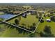 Aerial view of large acreage with home, detached garage, and pond at 3161 Appaloosa Ct, Kissimmee, FL 34746