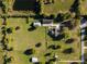 Aerial view of expansive property with home, pastures, detached garage, and a pond at 3161 Appaloosa Ct, Kissimmee, FL 34746