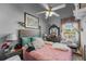 Comfortable bedroom with a ceiling fan, soft decor, and plenty of natural light at 3161 Appaloosa Ct, Kissimmee, FL 34746