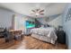 A cozy bedroom with a ceiling fan, TV, and unique two-toned wall design at 3161 Appaloosa Ct, Kissimmee, FL 34746