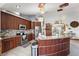 Open kitchen featuring custom cabinets, granite countertops, and stainless steel appliances at 3161 Appaloosa Ct, Kissimmee, FL 34746