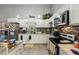Bright kitchen boasts white cabinets, stainless steel appliances, and a stylish backsplash at 3161 Appaloosa Ct, Kissimmee, FL 34746