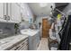 Well-equipped laundry room featuring a washer, dryer, and ample storage space at 3161 Appaloosa Ct, Kissimmee, FL 34746