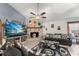 Cozy living room with a brick fireplace, ceiling fan, and comfortable seating arrangements at 3161 Appaloosa Ct, Kissimmee, FL 34746