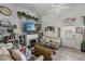 Bright living room with a fireplace, TV and view of the backyard at 3161 Appaloosa Ct, Kissimmee, FL 34746