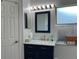 Bathroom featuring a sink vanity with marble countertop and frosted glass window at 3874 Blackberry Cir, St Cloud, FL 34769