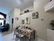 Inviting dining area featuring neutral paint, tile flooring, and decor shelf, creating a cozy atmosphere at 3874 Blackberry Cir, St Cloud, FL 34769