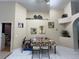 Cozy dining area with tile flooring, decor shelf, and bright natural light, creating a welcoming space at 3874 Blackberry Cir, St Cloud, FL 34769