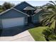 Lovely single-Gathering home with a two-car garage, well-manicured lawn, and palm trees at 3874 Blackberry Cir, St Cloud, FL 34769