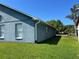 Exterior side view of the house shows the stucco finish and green lawn in the yard at 3874 Blackberry Cir, St Cloud, FL 34769