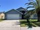 Exterior shot of the home showing its garage, front door, and well-manicured lawn at 3874 Blackberry Cir, St Cloud, FL 34769