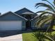 Inviting exterior showcasing the home's architectural details, two car garage, and lush landscaping at 3874 Blackberry Cir, St Cloud, FL 34769