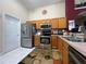 Bright kitchen featuring stainless steel appliances, light wood cabinets, and a patterned floor rug at 3874 Blackberry Cir, St Cloud, FL 34769