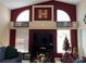 View of the living room showcasing high ceilings, fireplace, and large windows for natural light at 3874 Blackberry Cir, St Cloud, FL 34769