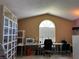Upstairs office space features large arched window, vaulted ceiling, and ample natural light at 3874 Blackberry Cir, St Cloud, FL 34769