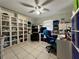 This home office features tiled floors, a ceiling fan and built in storage, perfect for working from home at 3874 Blackberry Cir, St Cloud, FL 34769
