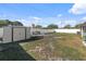 Spacious backyard featuring a storage shed, bench, and a white privacy fence, perfect for outdoor activities at 4548 Cepeda St, Orlando, FL 32811