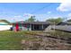 View of the back of the house featuring solar panels and a fenced yard at 4548 Cepeda St, Orlando, FL 32811