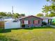 Inviting single-story home featuring a well-maintained lawn, a white privacy fence, and freshly painted exterior at 4548 Cepeda St, Orlando, FL 32811