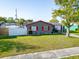 Attractive single-Gathering home with a well-kept lawn, mature tree, a white privacy fence, and gray exterior at 4548 Cepeda St, Orlando, FL 32811