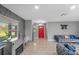 Living room with modern fireplace, stylish decor and gray sofa with blue and gold pillows at 4548 Cepeda St, Orlando, FL 32811