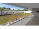 Covered patio overlooking a large backyard with a storage shed, bench and white privacy fence at 4548 Cepeda St, Orlando, FL 32811