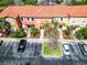 Aerial view showcasing the townhomes with colorful facades, landscaping, and convenient parking at 4743 Vero Beach Pl, Kissimmee, FL 34746