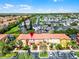 Aerial view of colorful townhomes with red tile roofs, lush landscaping, and parking at 4743 Vero Beach Pl, Kissimmee, FL 34746