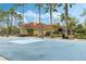 A vibrant outdoor basketball court surrounded by lush landscaping and palm trees on a sunny day at 4743 Vero Beach Pl, Kissimmee, FL 34746