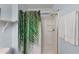 Bright bathroom featuring shower and a modern tropical themed curtain at 4743 Vero Beach Pl, Kissimmee, FL 34746