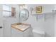 Bright and tidy bathroom with a vanity, round mirror, and natural light from the window at 4743 Vero Beach Pl, Kissimmee, FL 34746