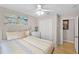 Bright bedroom features stylish bed frame, colorful artwork, ceiling fan, and double door closet at 4743 Vero Beach Pl, Kissimmee, FL 34746
