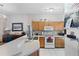Bright kitchen with oak cabinets and white appliances, offering a cozy space at 4743 Vero Beach Pl, Kissimmee, FL 34746