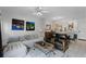 A bright open living room with modern decor, tile floors, and seamlessly connected spaces at 4743 Vero Beach Pl, Kissimmee, FL 34746