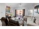 Living room featuring neutral tones, plush sofa, access to the outdoor patio with brick pavers at 4743 Vero Beach Pl, Kissimmee, FL 34746