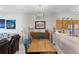 Cozy open-concept living area with wood table, bright light fixture and colorful art at 4743 Vero Beach Pl, Kissimmee, FL 34746