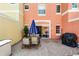 Cozy patio with a seating area, grill, and sliding door access to the interior at 4743 Vero Beach Pl, Kissimmee, FL 34746