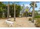 Community recreation area with gravel ground, bench seating, and mature trees at 4743 Vero Beach Pl, Kissimmee, FL 34746