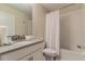 Well-lit bathroom with a sleek vanity, modern fixtures, and a shower-tub combo at 481 Ocean Course Ave, Davenport, FL 33896